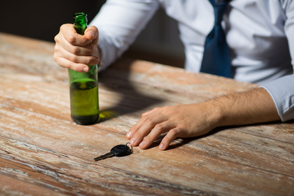 hands with alcohol and car key